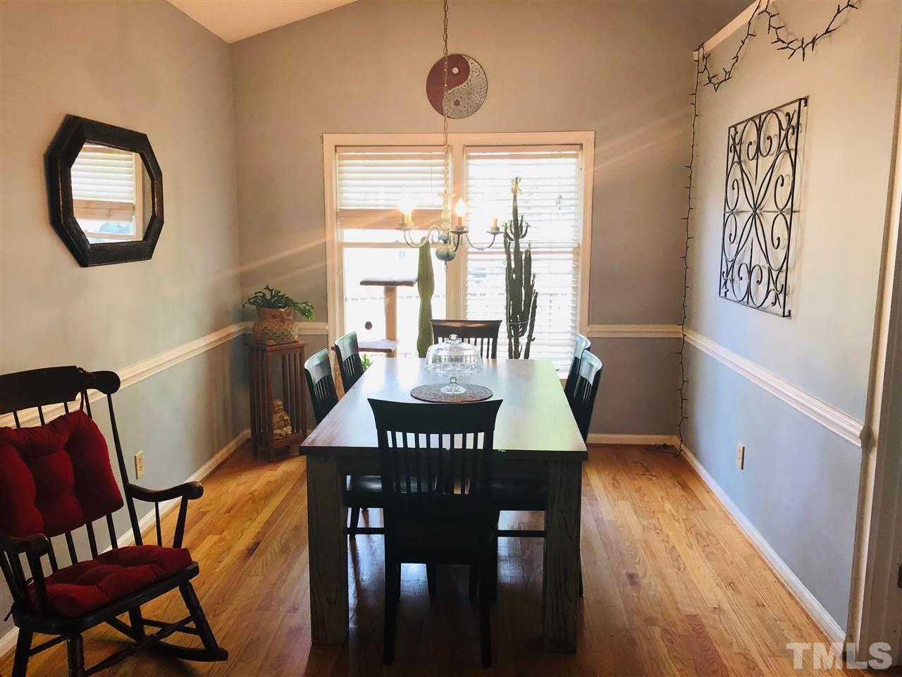 5601 Edgebury Road Raleigh, NC 27613 - Photo 7 of 12 a view of a dining room with furniture window and wooden floor