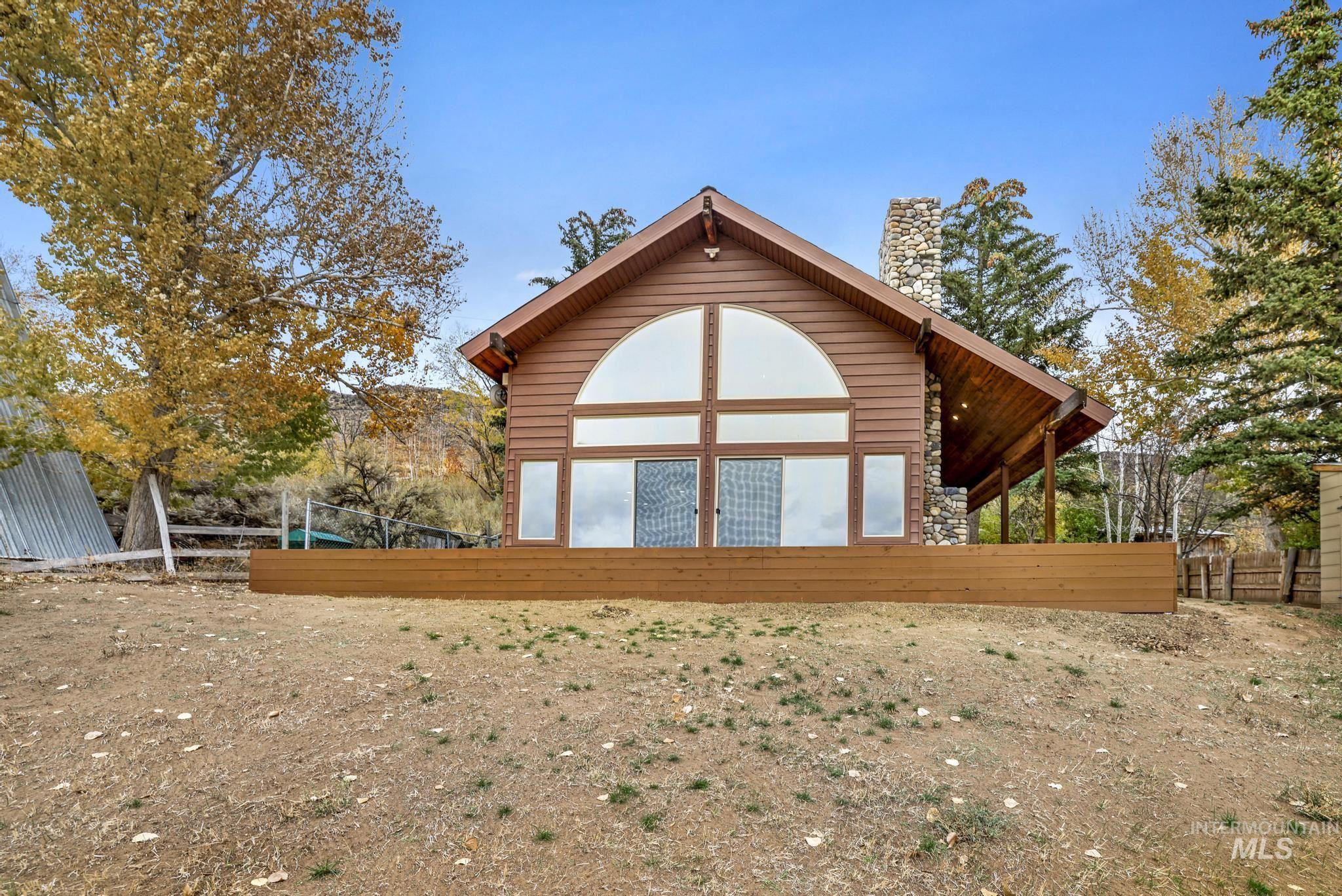 Rear view of property featuring a chimney