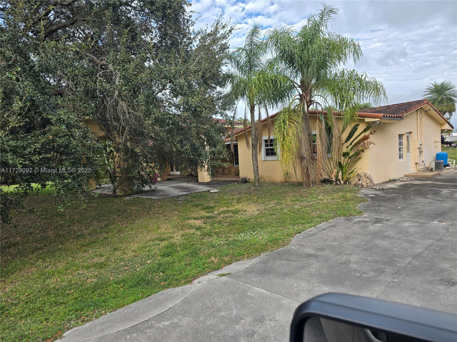 Country Club Ranches Miramar, FL 33027 - Photo 4 of 29 a front view of house with yard and trees