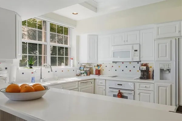 a kitchen with stainless steel appliances a sink a stove and a window