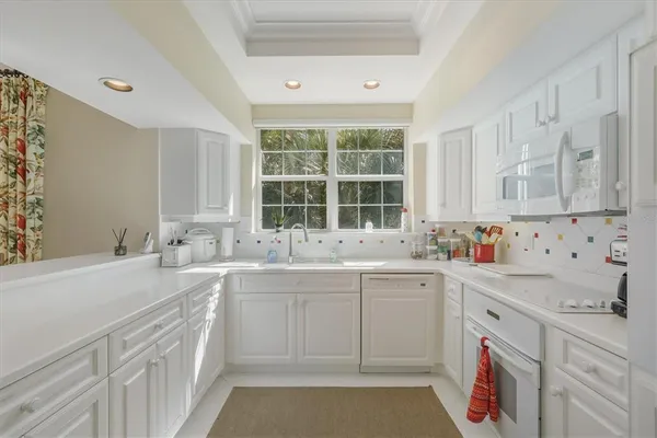 a kitchen with a sink stove and cabinets