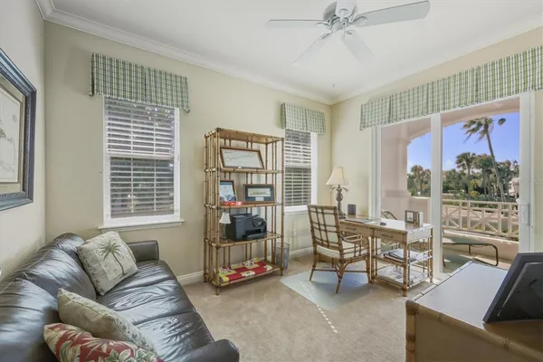 a living room with furniture and a floor to ceiling window