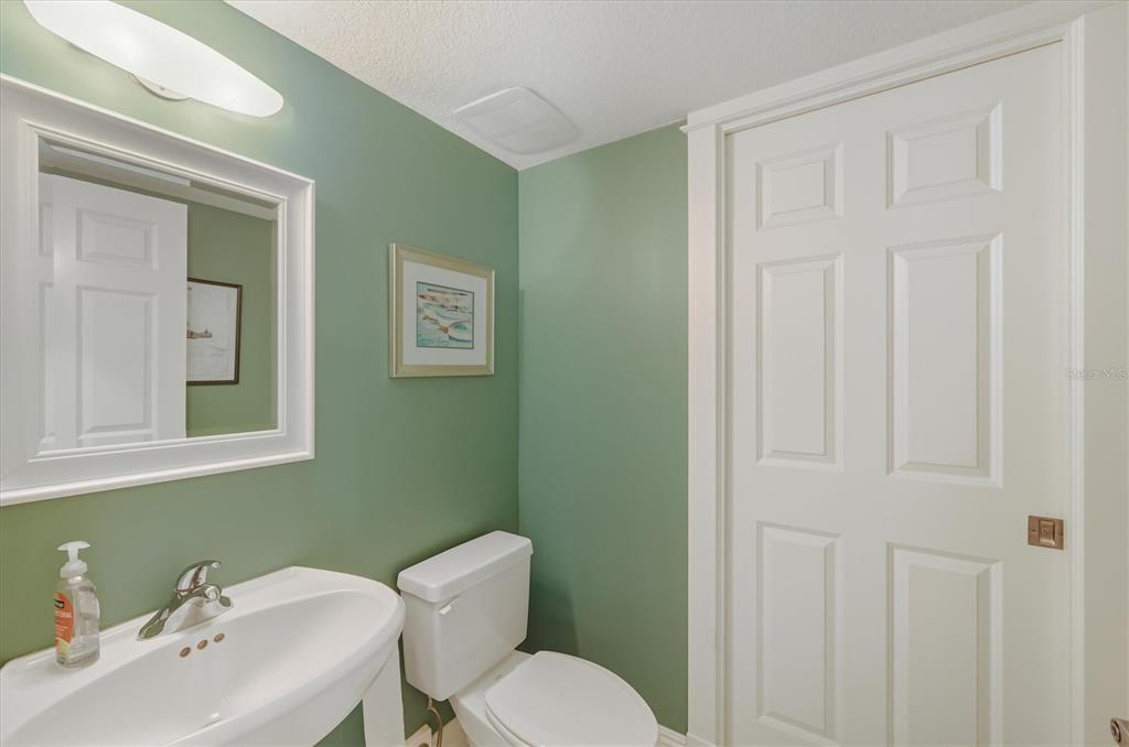 767 South Harbor Drive, Unit 1B Boca Grande, FL 33921 - Photo 30 of 55 a bathroom with a toilet a sink and mirror