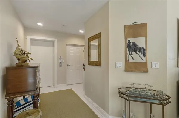 a view of a hallway with workspace and a window