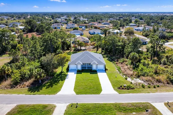 an aerial view of multiple houses with yard