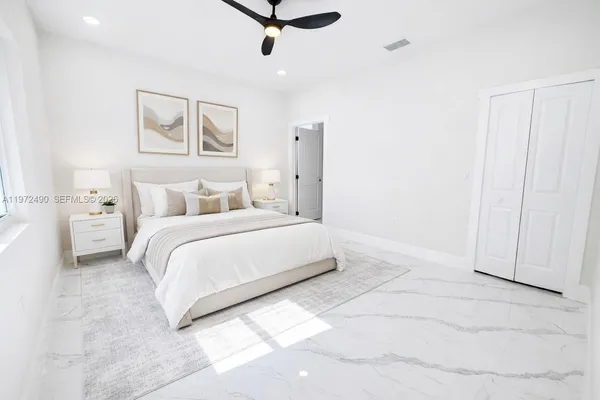 a bathroom with a toilet a sink and shower curtain