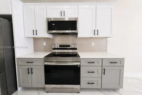 a stove top oven sitting inside of a kitchen