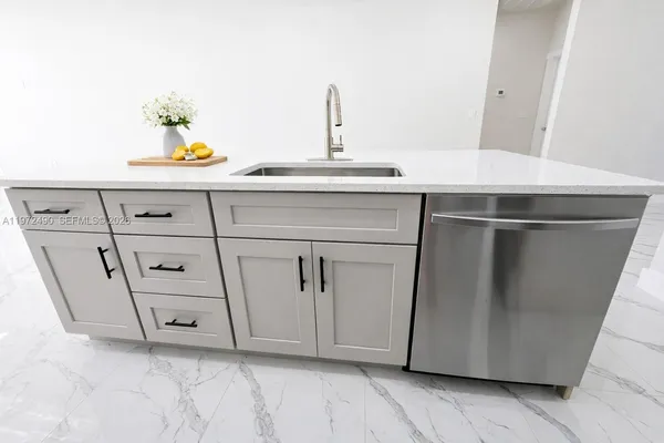 a kitchen with a sink and cabinets