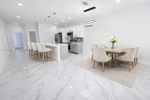 a dining room with furniture and a view of kitchen