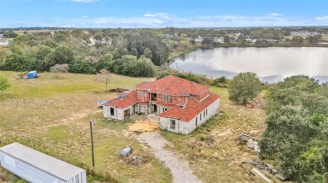an aerial view of a house with a yard