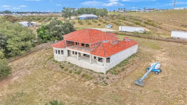 an aerial view of a house with a ocean view