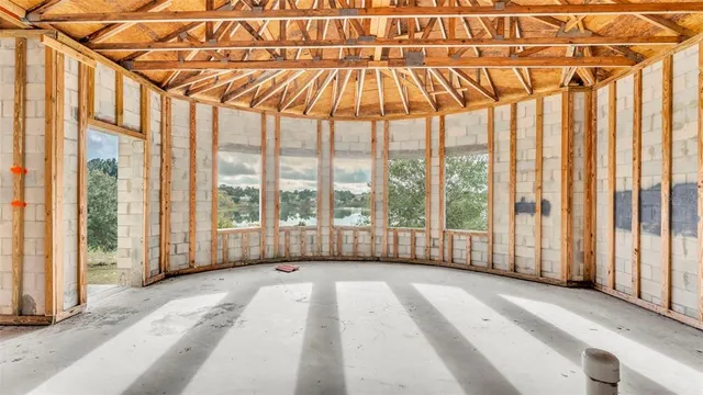 a bedroom with furniture and a large window