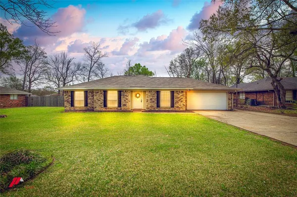 a front view of a house with a yard table and chairs