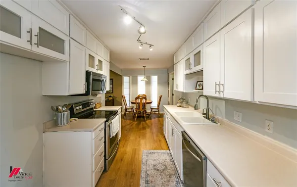 a kitchen with a sink dishwasher and cabinets