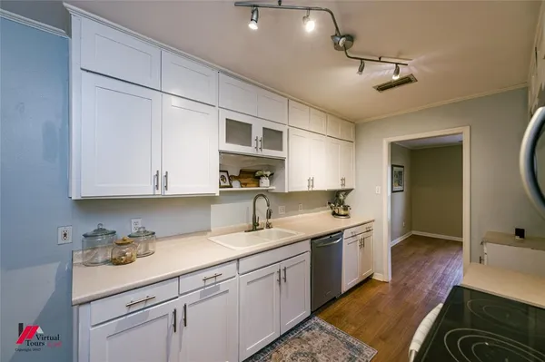 a kitchen with stainless steel appliances a stove microwave and cabinets