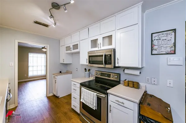 a view of a dining room with furniture and a chandelier