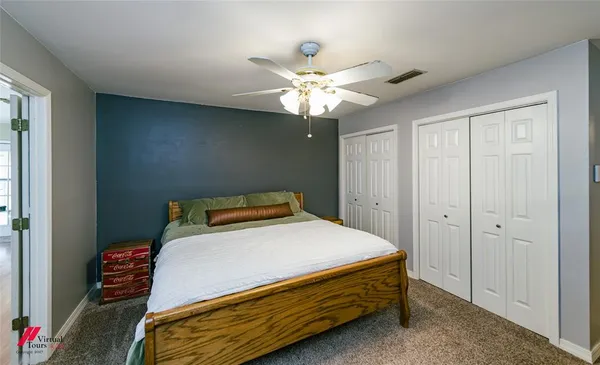 a room with pool table and wooden floor