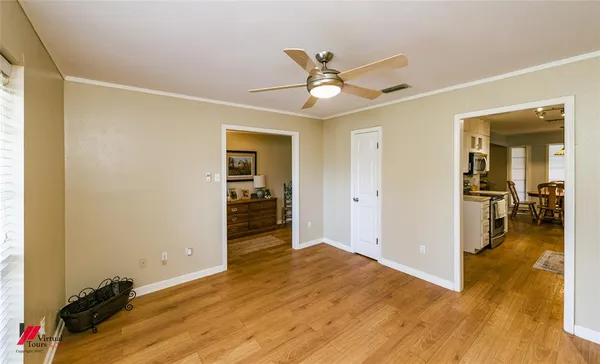 a kitchen with counter top space a sink wooden floor and cabinets