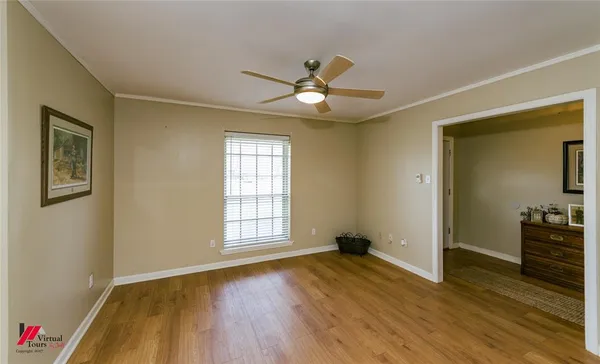 a kitchen with a sink dishwasher a stove and white cabinets with wooden floor