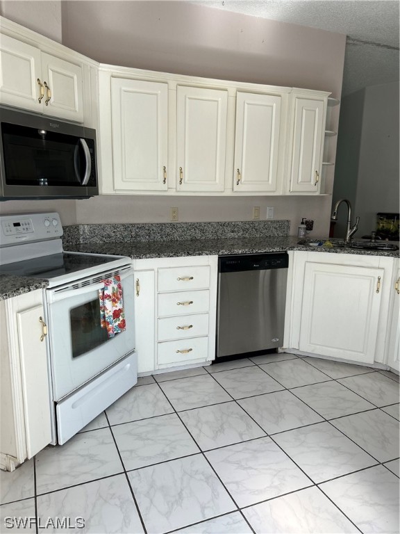 905 Manatee Road Naples, FL 34114 - Photo 8 of 25 a kitchen with stainless steel appliances granite countertop a stove a sink and a microwave