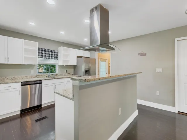 a kitchen with stainless steel appliances a refrigerator and stove
