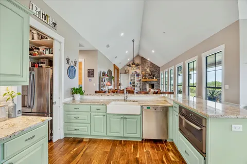 a kitchen with stainless steel appliances granite countertop a sink and cabinets