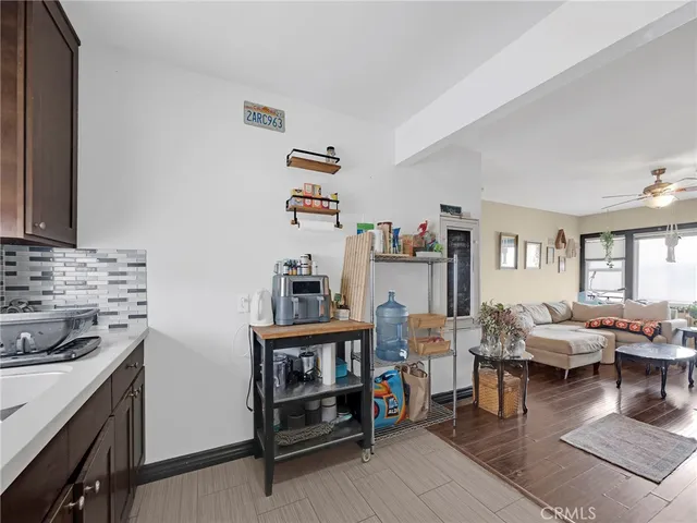 a living room with furniture and a kitchen view