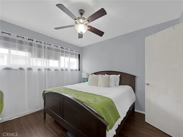 a bedroom with a bed and a large window