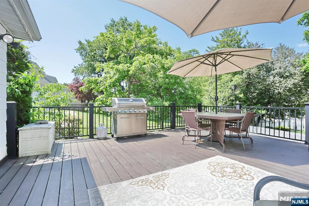 30 Brookfield Road Dumont, NJ 07628 - Photo 36 of 50 an outdoor space with furniture and umbrella