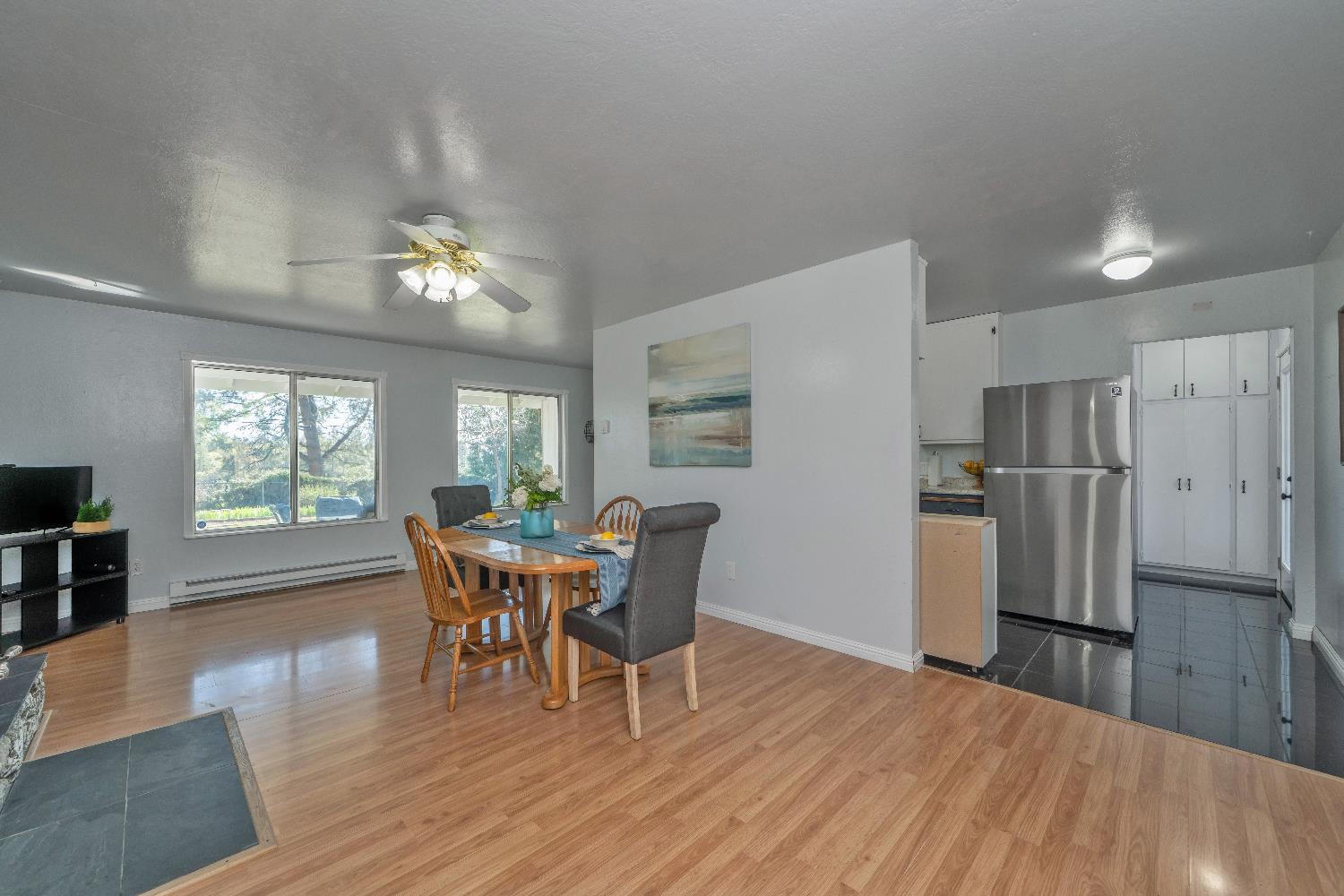 6261 Grizzly Flat Road Somerset, CA 95684 - Photo 21 of 63 a dining room with furniture a chandelier and wooden floor
