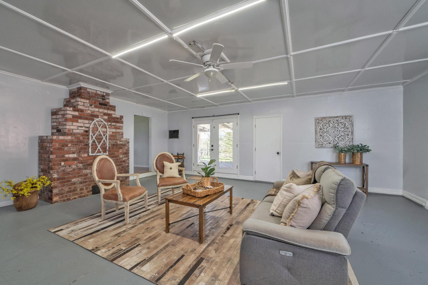 6261 Grizzly Flat Road Somerset, CA 95684 - Photo 23 of 63 a living room with furniture and a fireplace