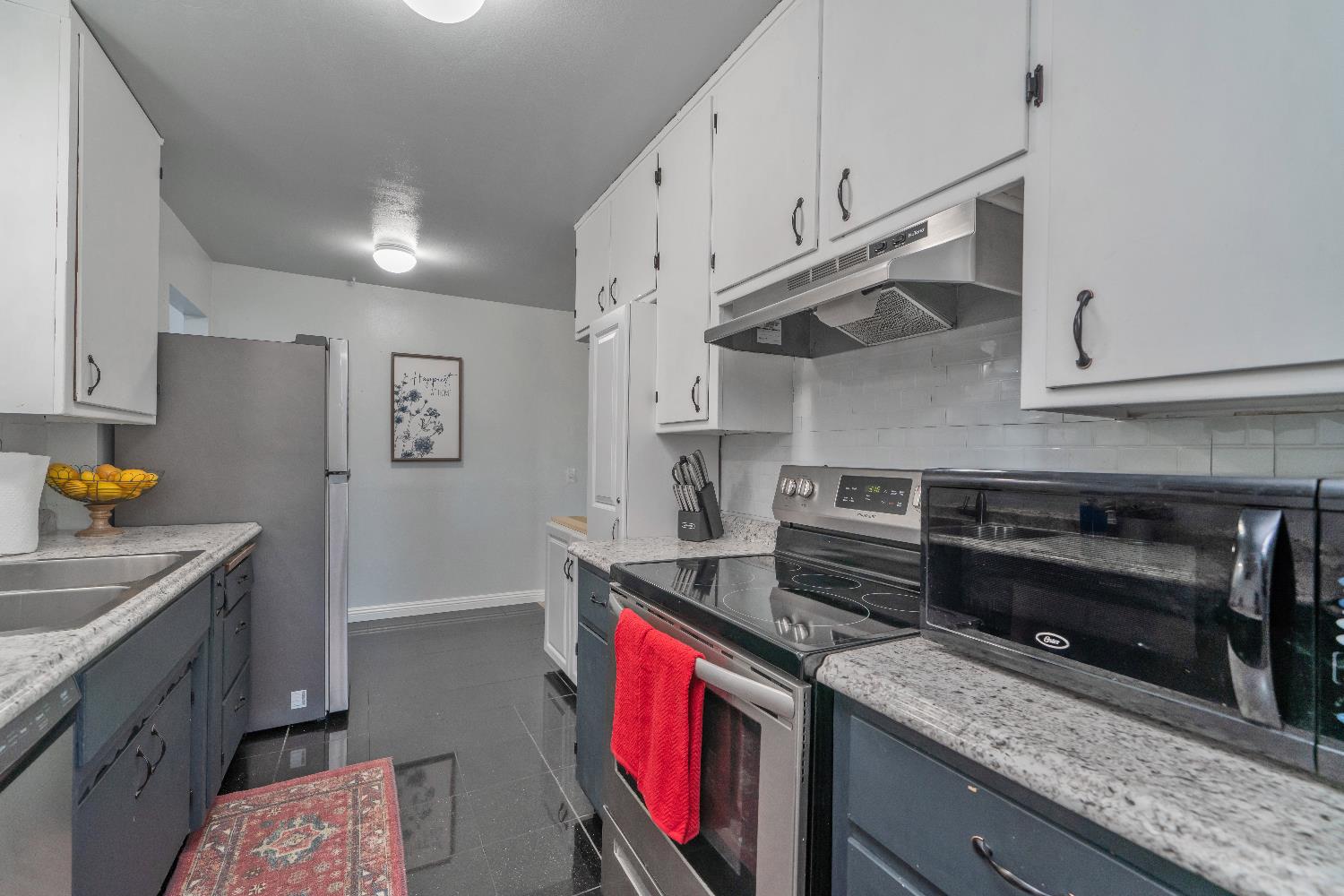 6261 Grizzly Flat Road Somerset, CA 95684 - Photo 26 of 63 a kitchen with stainless steel appliances granite countertop a stove a sink and a refrigerator