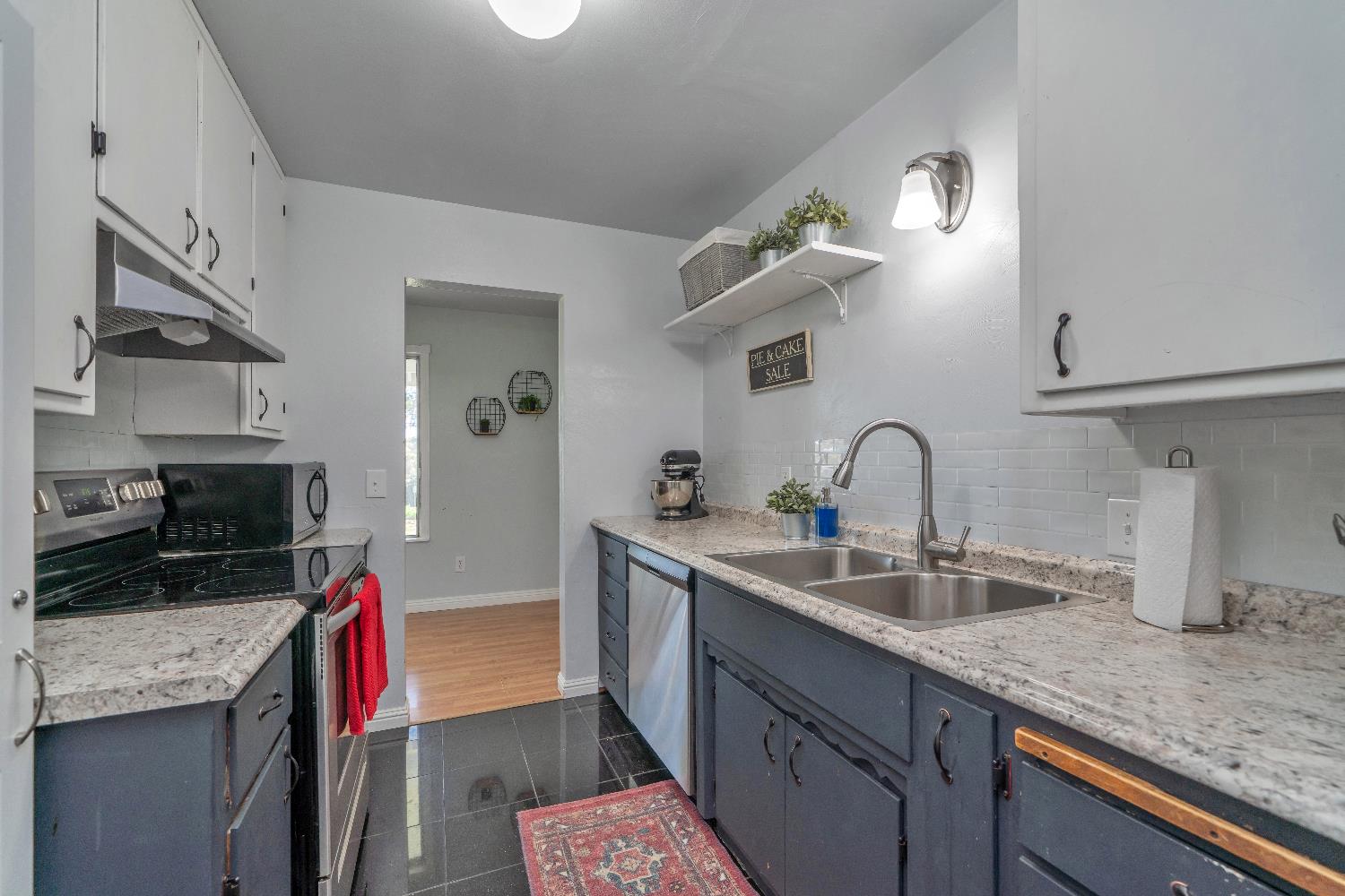 6261 Grizzly Flat Road Somerset, CA 95684 - Photo 27 of 63 a kitchen with sink a stove and cabinets