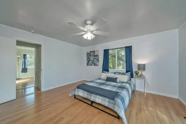 a room with wooden floor and couch