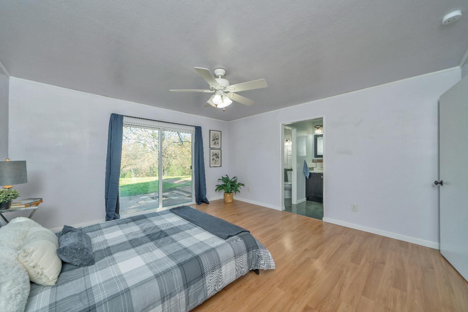 6261 Grizzly Flat Road Somerset, CA 95684 - Photo 31 of 63 a bedroom with a large bed and a chandelier