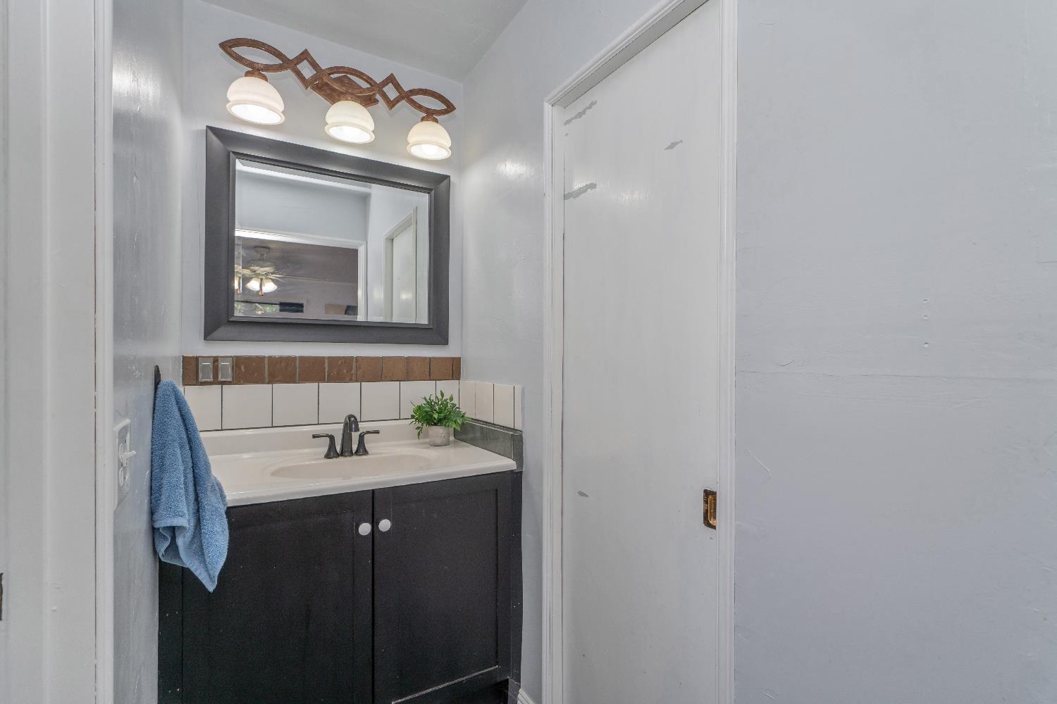 6261 Grizzly Flat Road Somerset, CA 95684 - Photo 34 of 63 a bathroom with a toilet sink and mirror