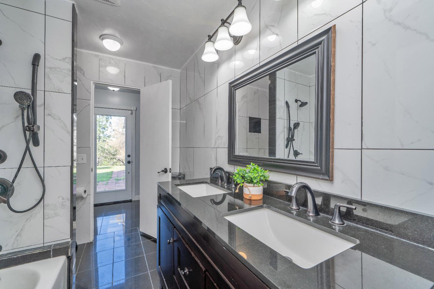 6261 Grizzly Flat Road Somerset, CA 95684 - Photo 40 of 63 a bathroom with a sink a vanity and a mirror