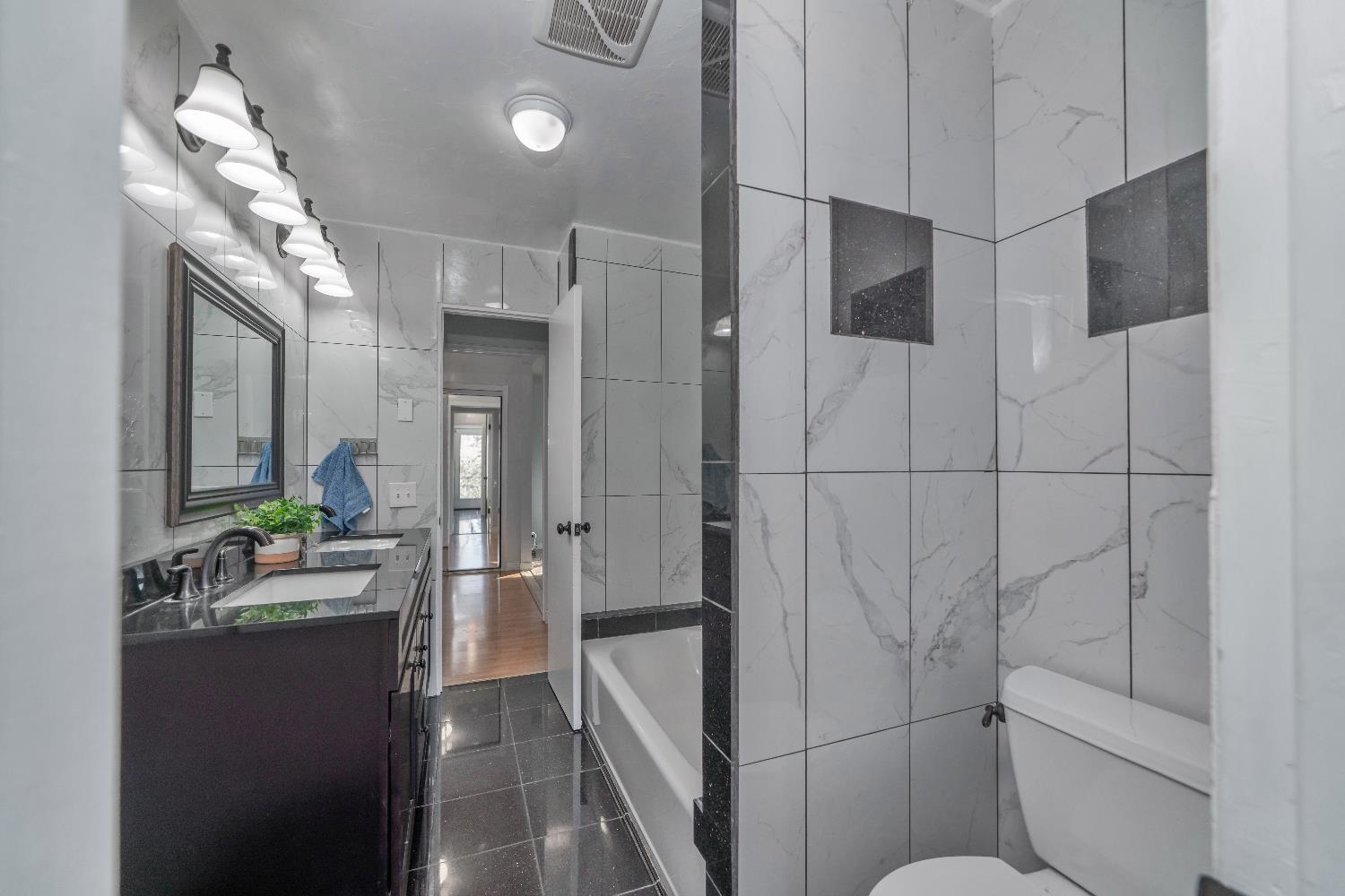 6261 Grizzly Flat Road Somerset, CA 95684 - Photo 42 of 63 a bathroom with a sink and mirror with toilet