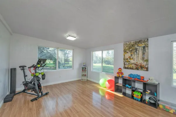 a view of a field with trees in the background