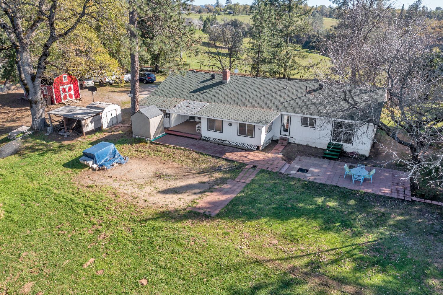 6261 Grizzly Flat Road Somerset, CA 95684 - Photo 47 of 63 a backyard of a house with table and chairs