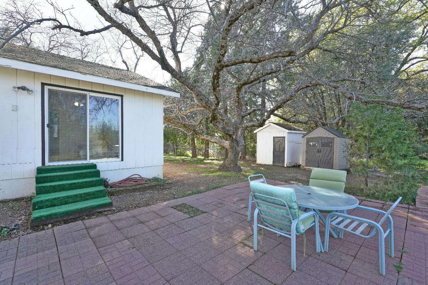 6261 Grizzly Flat Road Somerset, CA 95684 - Photo 51 of 63 a front view of a house with a yard and seating area
