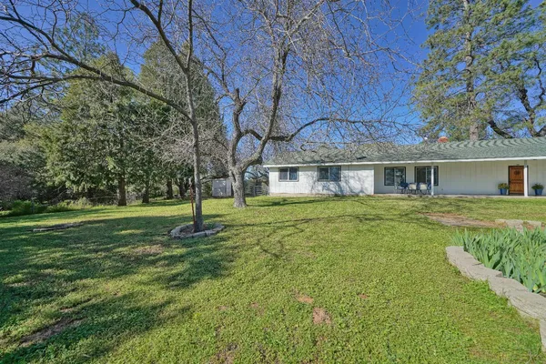 an aerial view of a house with a yard and lake view