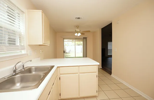 a kitchen that has a sink and a stove