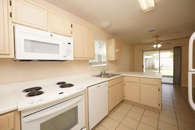 a kitchen with a sink a stove and cabinets