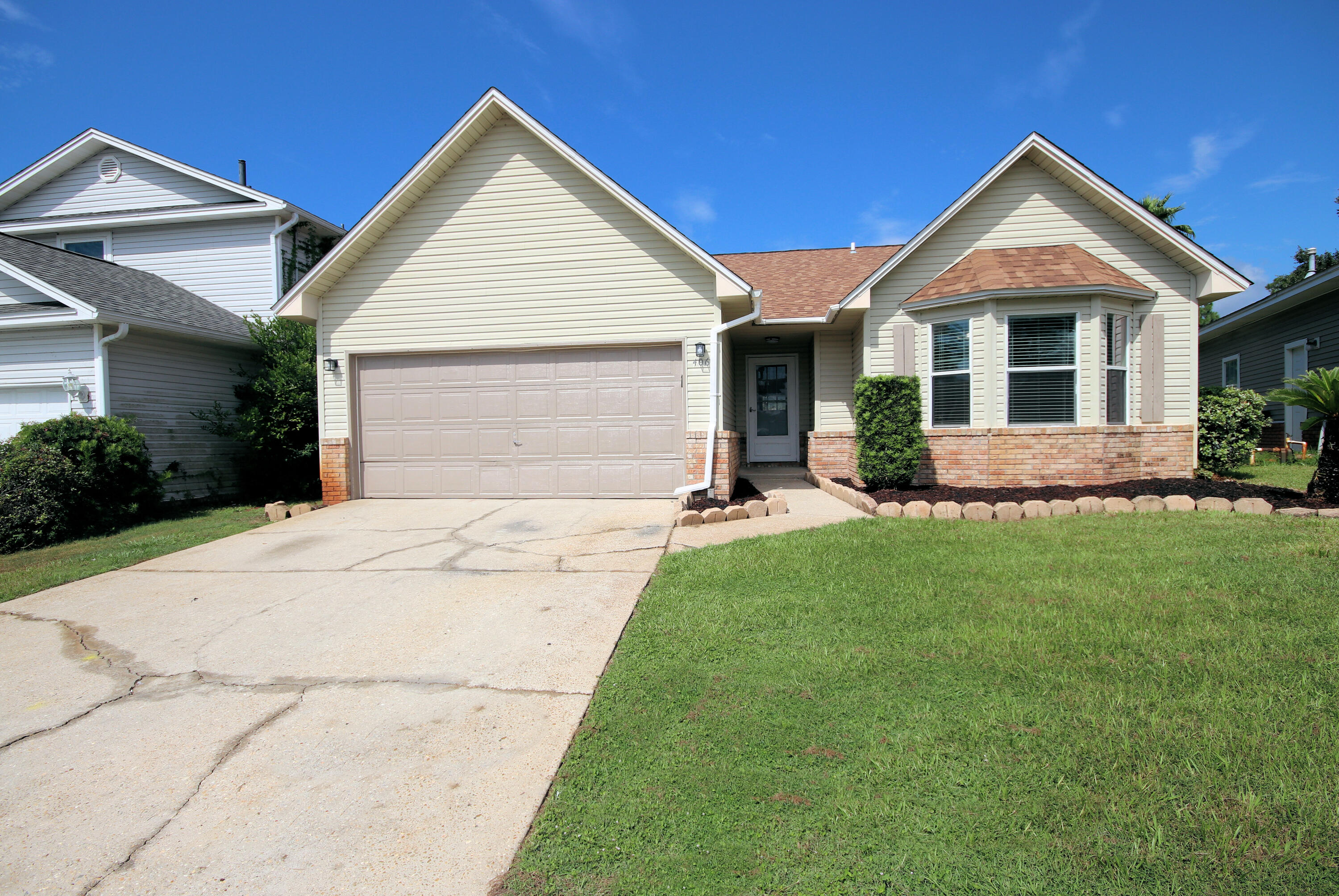 406 Springate Court Mary Esther, FL 32569 - Photo 2 of 41 a front view of house with yard and green space