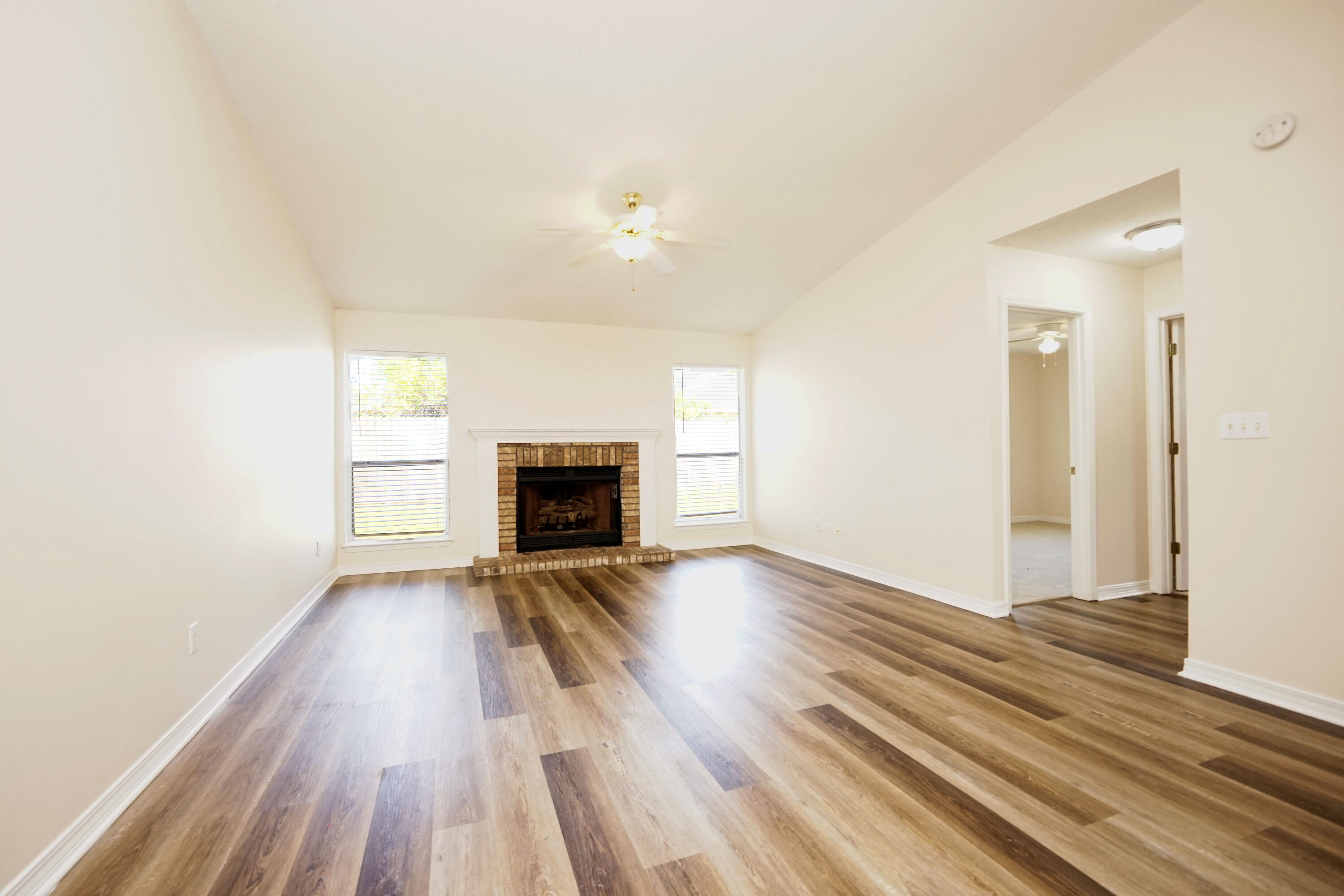 406 Springate Court Mary Esther, FL 32569 - Photo 7 of 41 wooden floor in an empty room with a fireplace