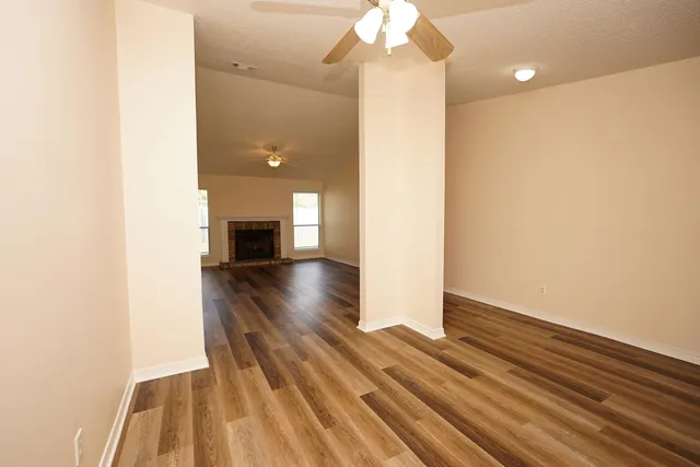 a view of livingroom and kitchen with wooden floor