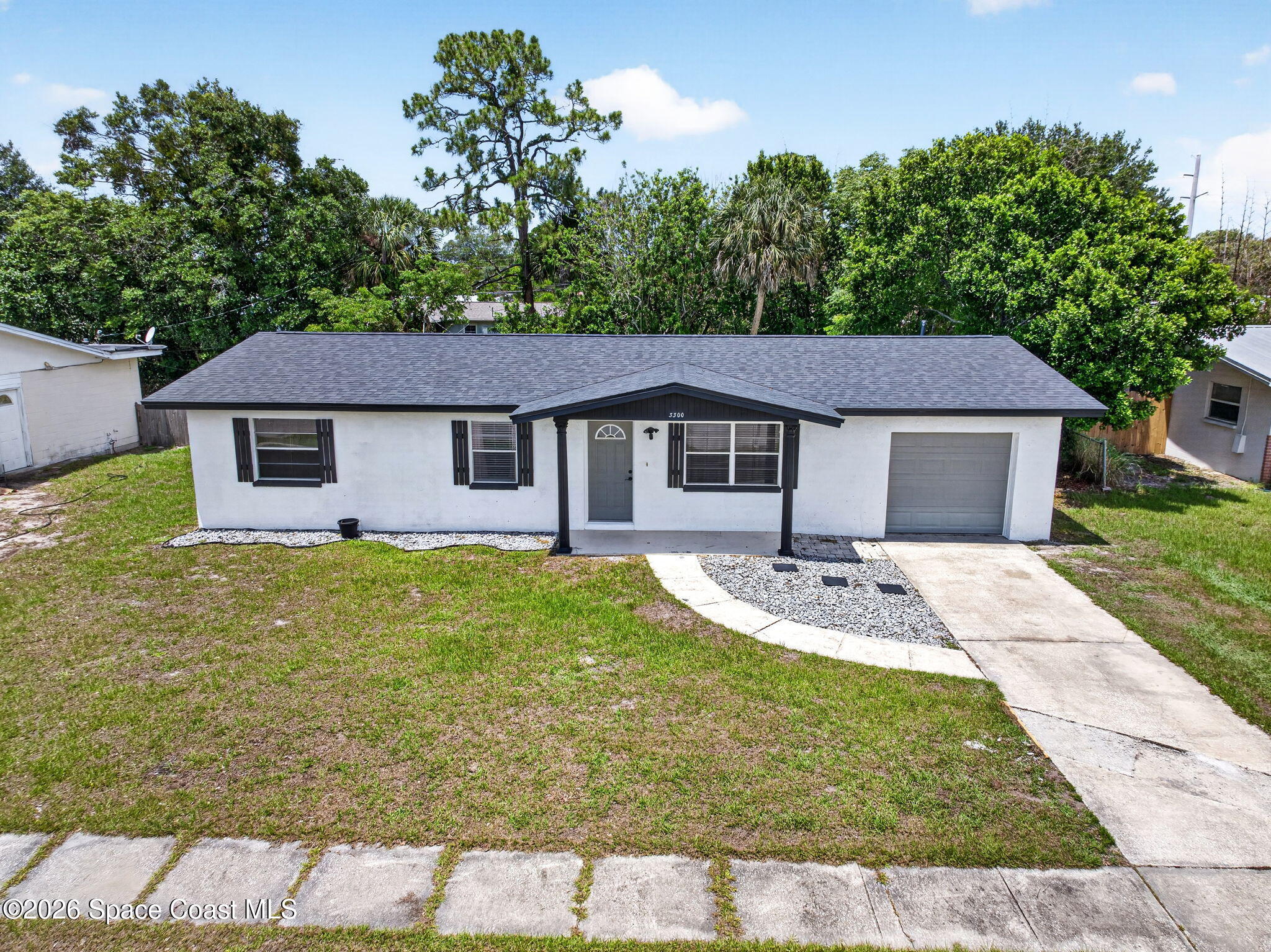 3300 Argyle Road Titusville, FL 32796 - Photo 6 of 29 a front view of a house with garden