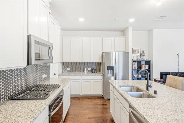 a kitchen with a sink stove and refrigerator