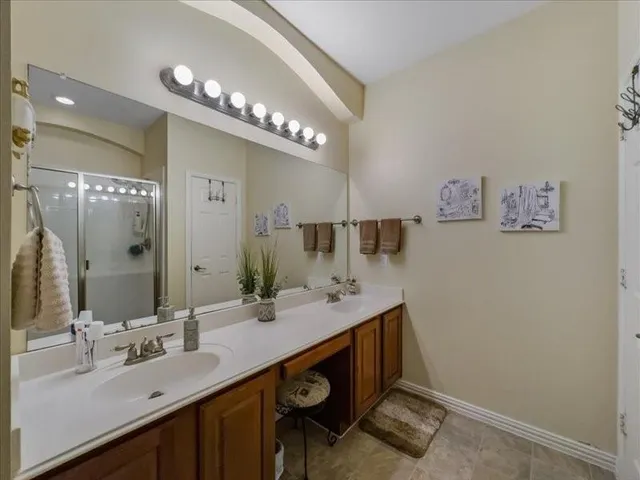 a bathroom with a sink double vanity and a mirror
